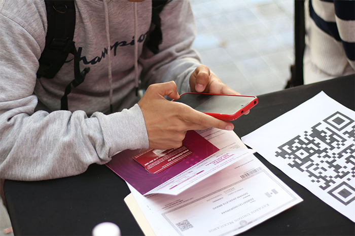 Estudiantes de la Universidad Michoacana haciendo fila en un módulo de entrega de tarjetas SIM D4TA del Gobierno de Michoacán.