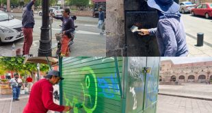 Personal de la Gerencia del Centro Histórico realizando trabajos de pintura y rehabilitación de mobiliario en una plaza de Morelia.