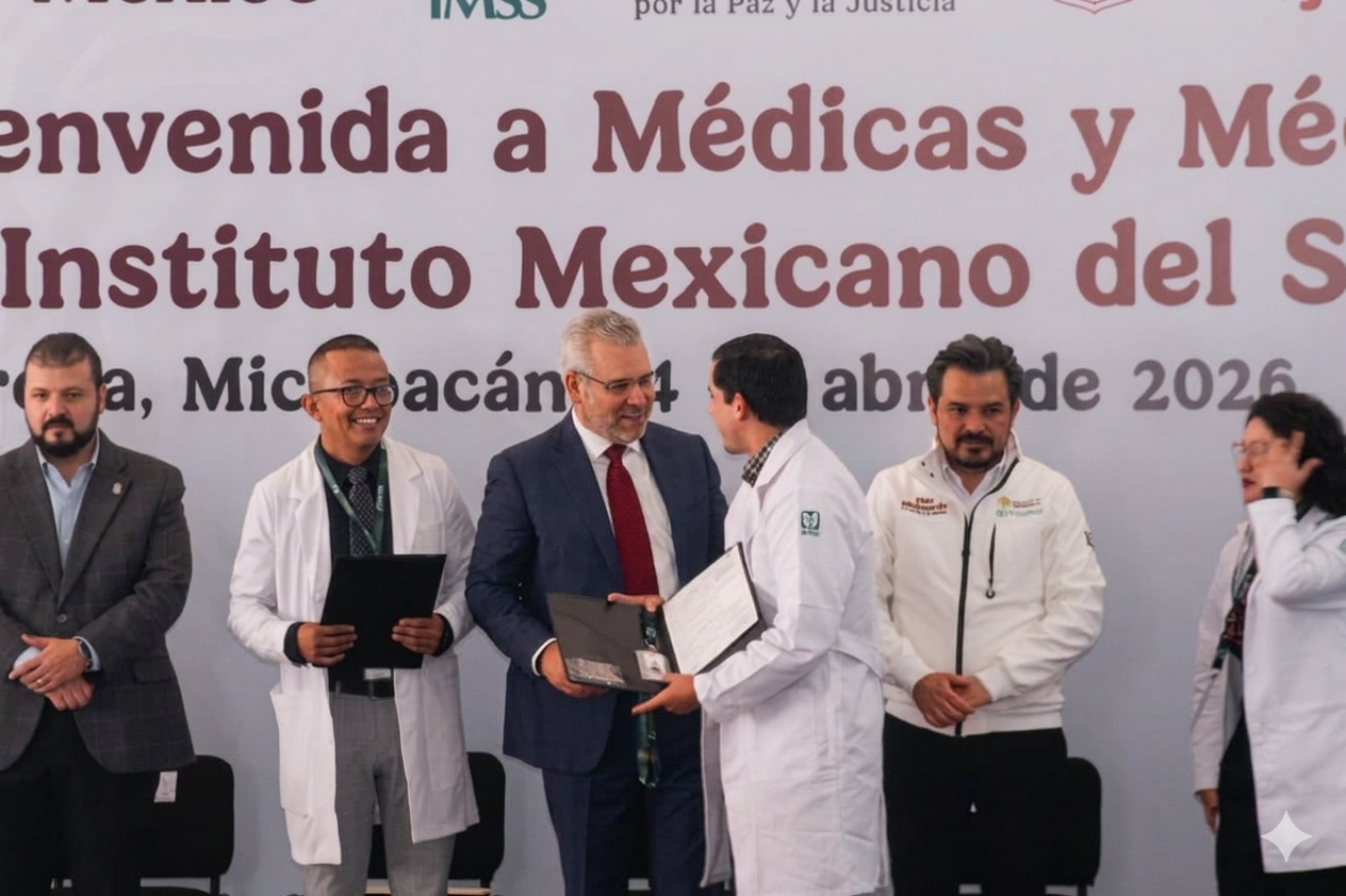 El gobernador Alfredo Ramírez Bedolla entrega documentos a un médico especialista durante el evento de bienvenida al IMSS en Michoacán.