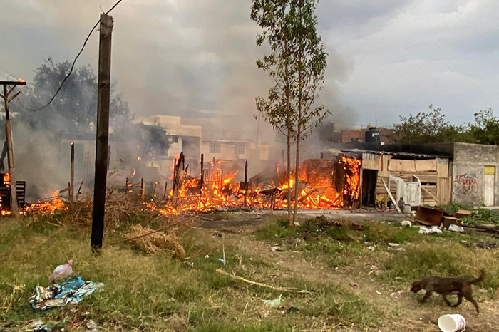 Bomberos de Morelia trabajando para sofocar el incendio en tres viviendas de madera en la colonia Ignacio López Rayón.