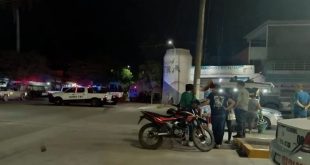 Elementos de la policía resguardan el autoservicio Freeway en Apatzingán tras un ataque armado.