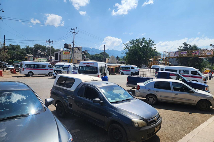 Unidades de transporte público atravesadas bloqueando la circulación en una carretera de Michoacán.