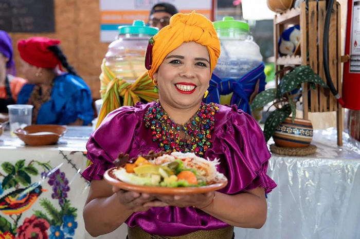 Cocineras tradicionales ofreciendo platillos típicos.