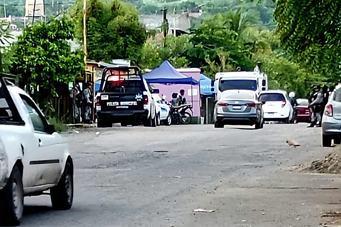Autoridades resguardan la escena donde un jornalero fue asesinado a balazos en la colonia Lázaro Cárdenas, en Apatzingán.