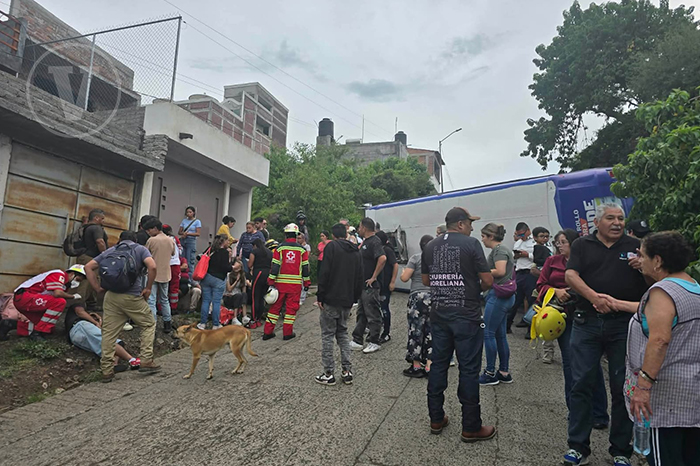 Unidades de emergencia y grúas atendiendo la volcadura de un camión del transporte público.