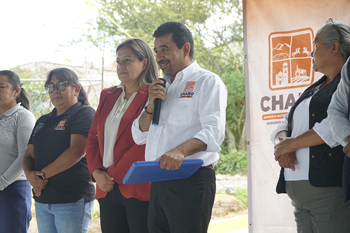 Autoridades municipales y vecinos realizando el corte de listón en una calle recién pavimentada.