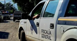Zona acordonada por elementos policiales tras el descubrimiento de un cuerpo en un terreno baldío.