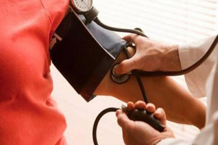 Estetoscopio sobre un fondo médico con gráficos de salud cardíaca para ilustrar la prevención de enfermedades cardiovasculares.