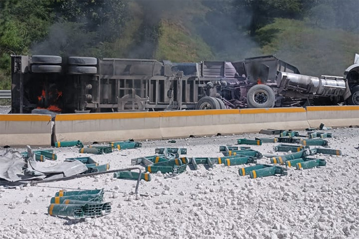 Tractocamión volcado y personal de emergencias laborando en la Autopista Siglo XXI.
