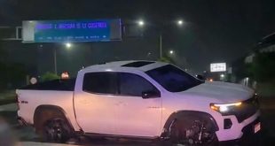 Unidades de emergencia y de la Guardia Nacional atendiendo el choque de una camioneta blanca sobre la carretera Apatzingán-Cuatro Caminos.