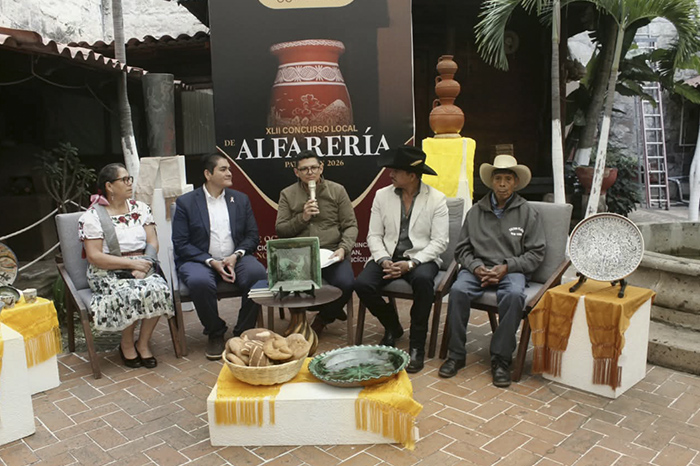 Artesanías de barro y alfarería bruñida expuestas sobre el suelo de la plaza principal de Patamban.